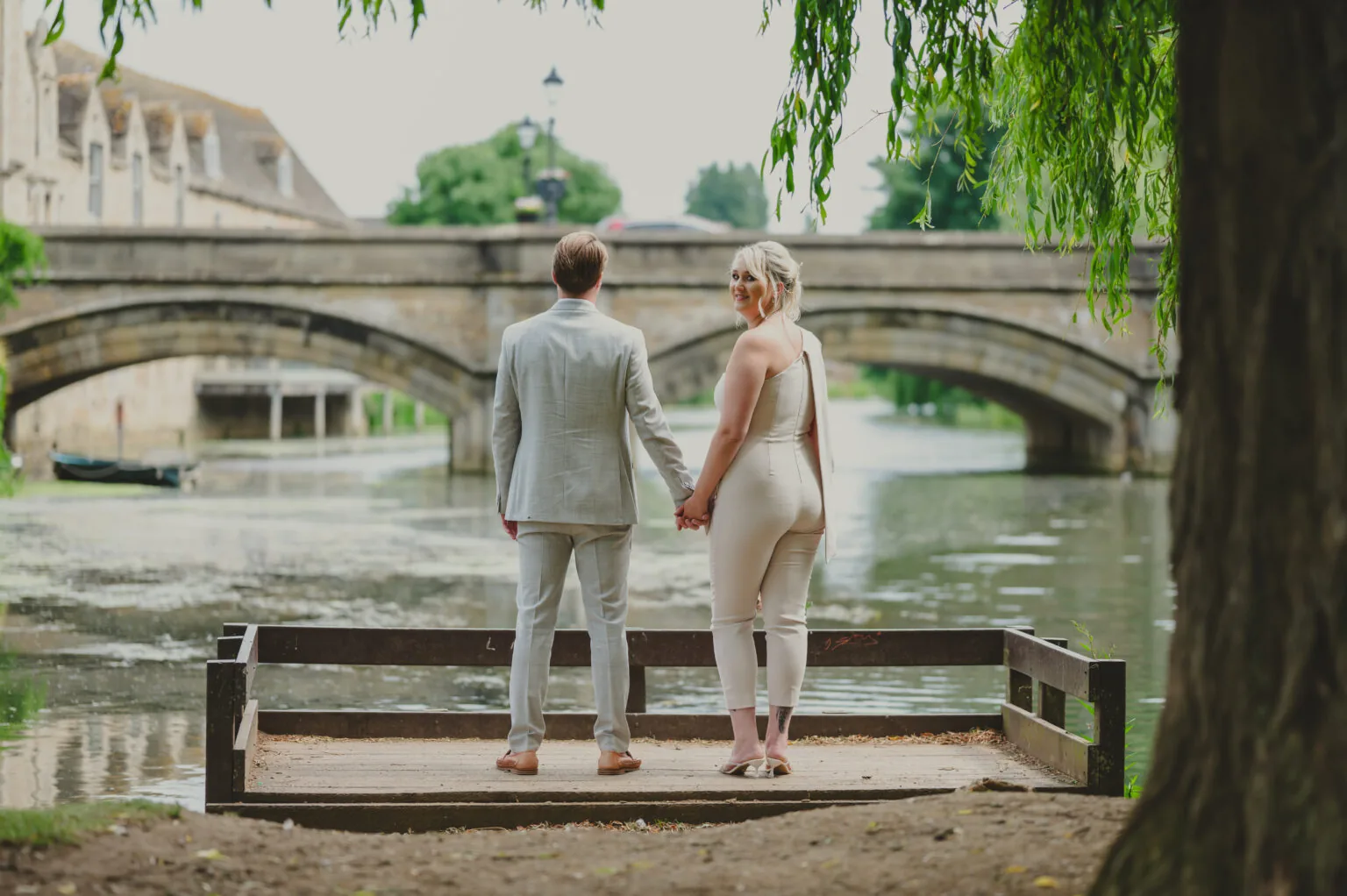 Couple on a stone bridge over a river