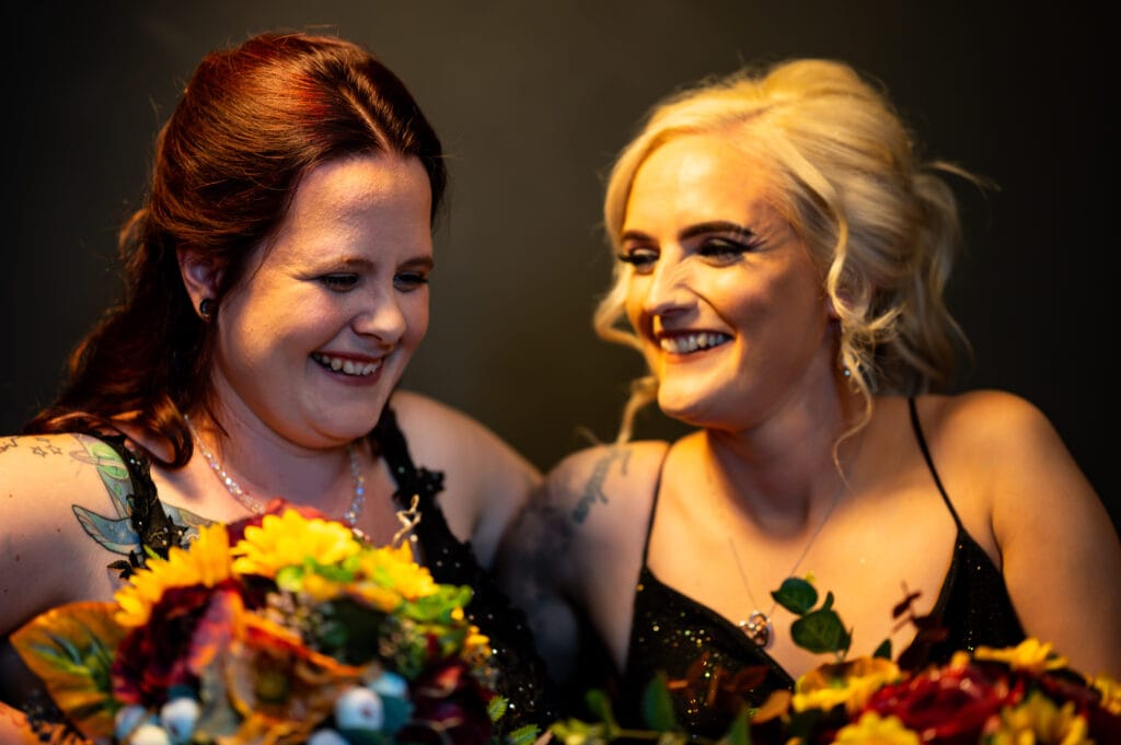 Chelsea and Erin laughing together with their bouquets