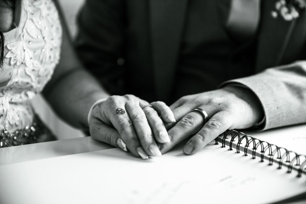 Hands signing the wedding register