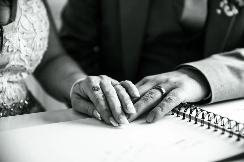 Hands signing the wedding register