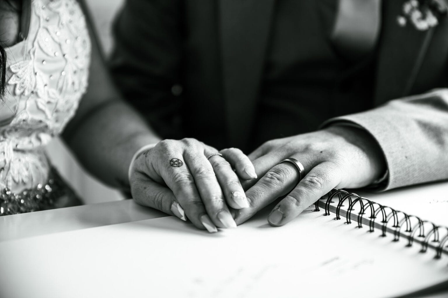 Hands signing the wedding register