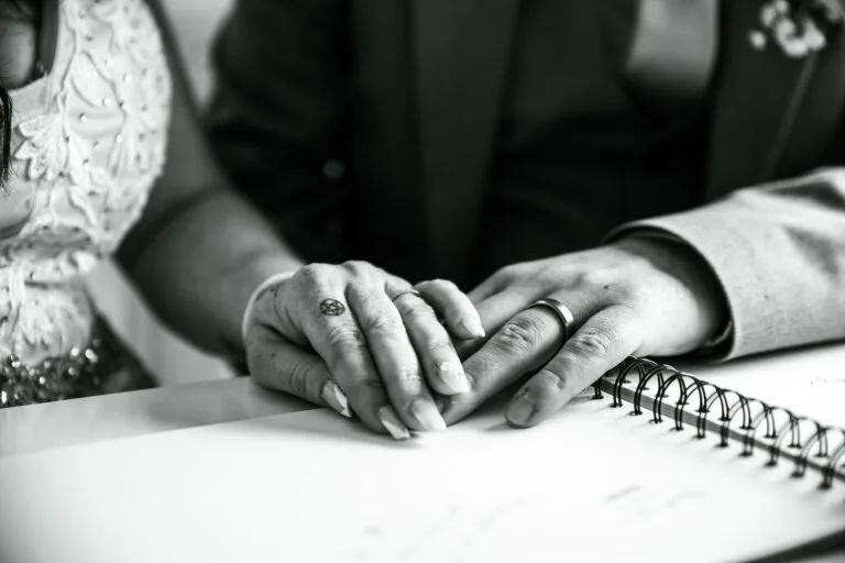 Hands signing the wedding register