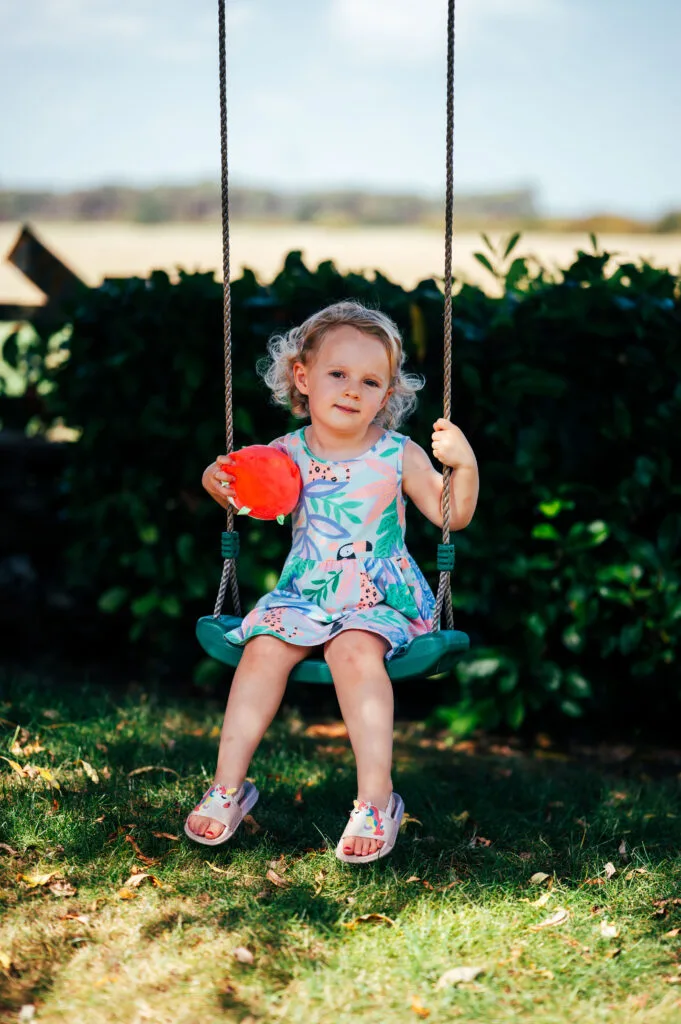 Girl on a garden swing