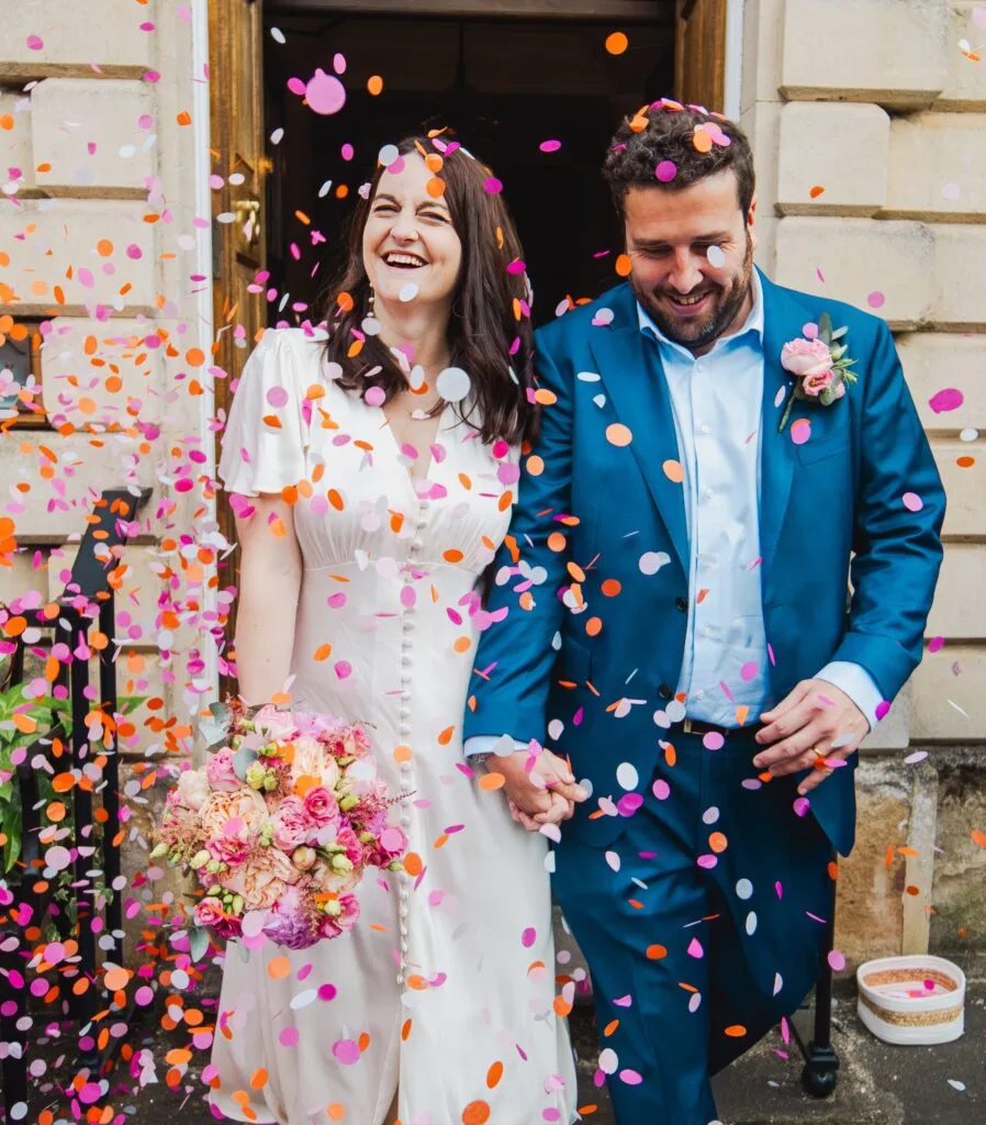 Couple laughing in a shower of confetti