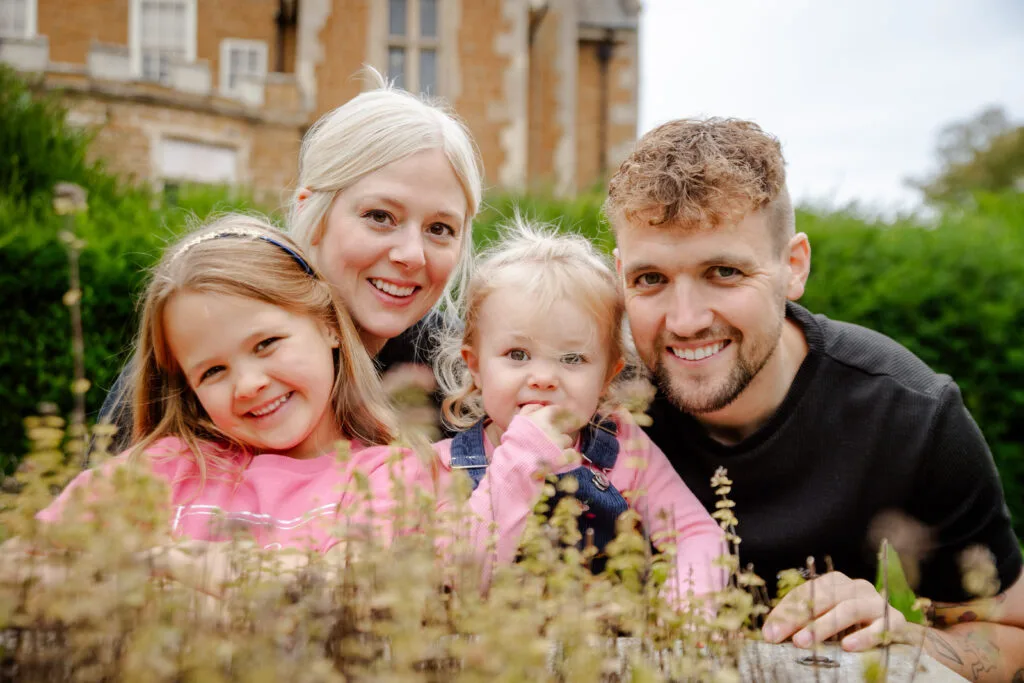 Parents and two daughters smiling together