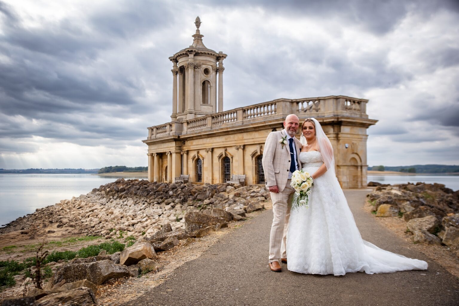 Bride and groom in front of Normanton Church on Rutland Water