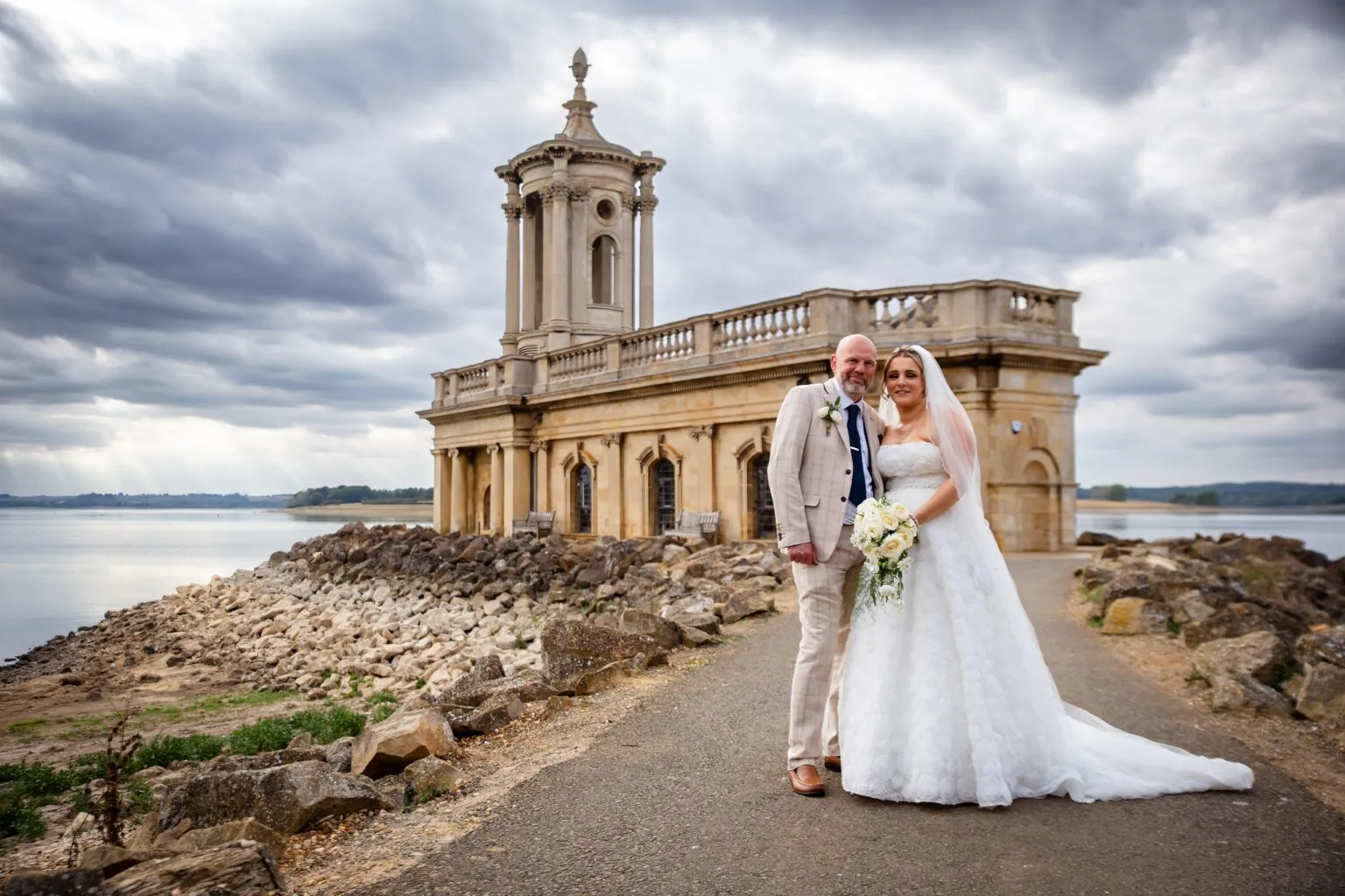 Bride and groom in front of Normanton Church on Rutland Water