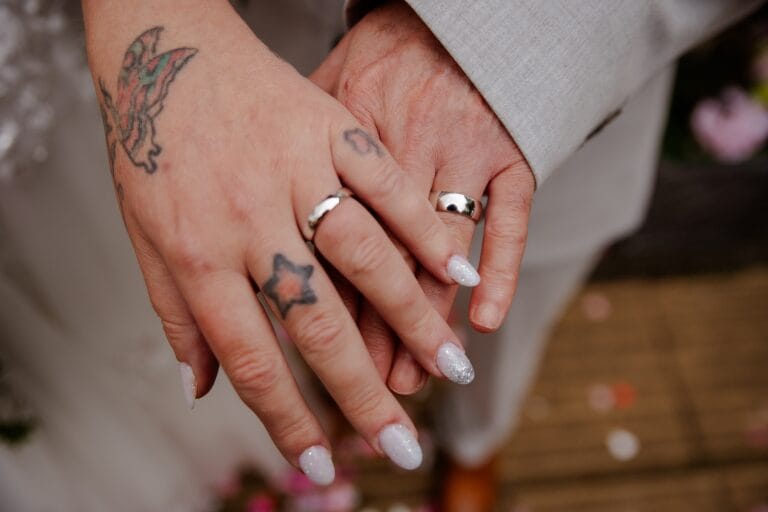 Close-up of the couple holding hands