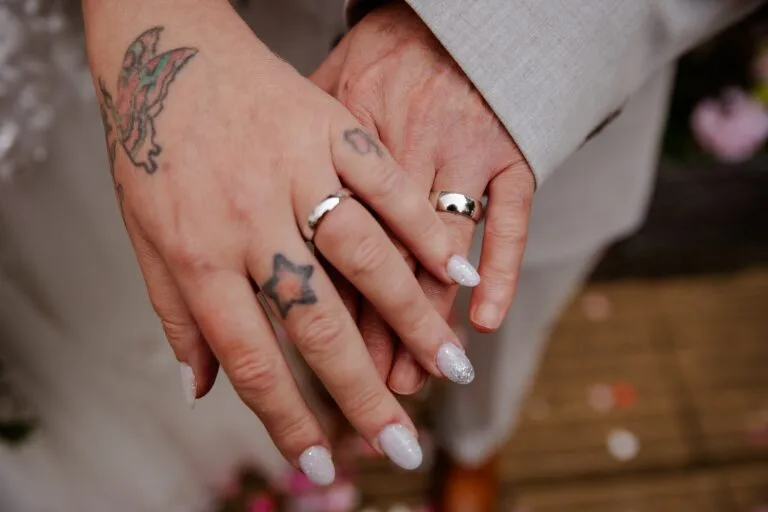 Close-up of the couple holding hands