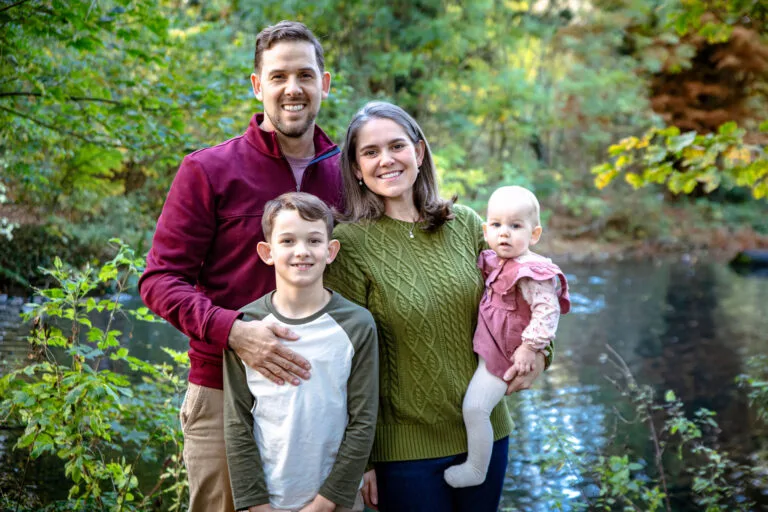 Family portrait beside a river