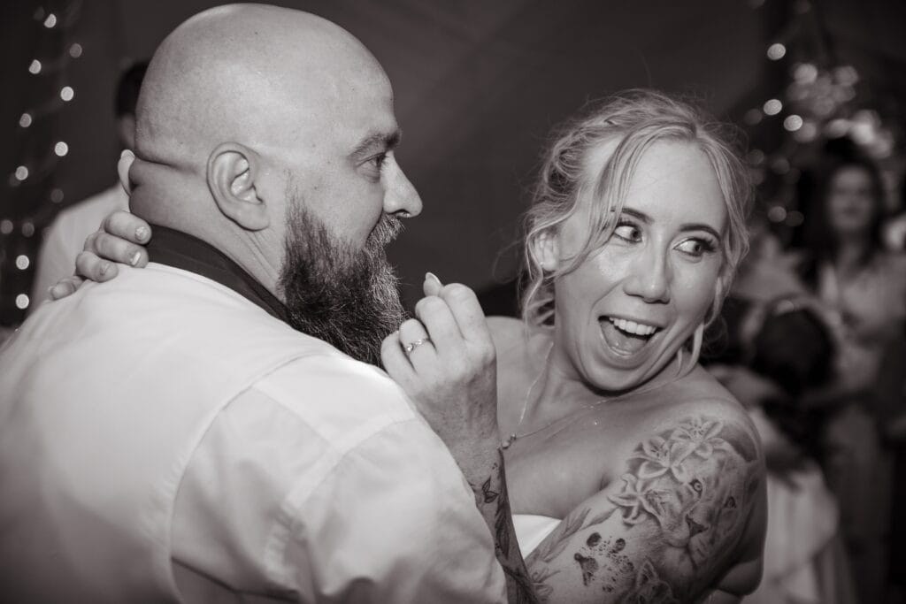 Black and white photo of two guests laughing together