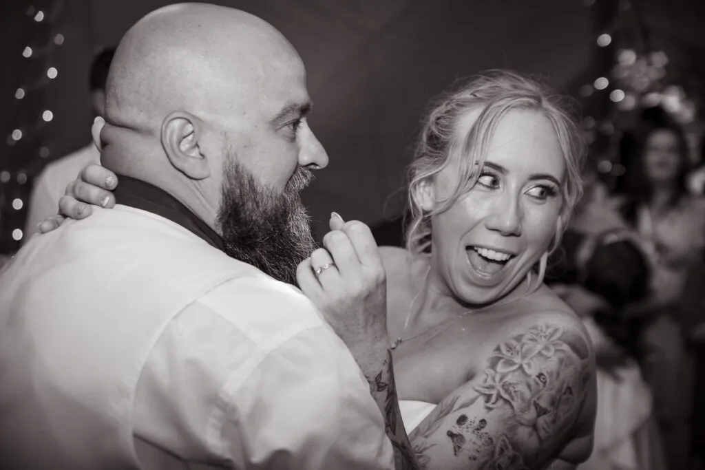 Black and white photo of two guests laughing together